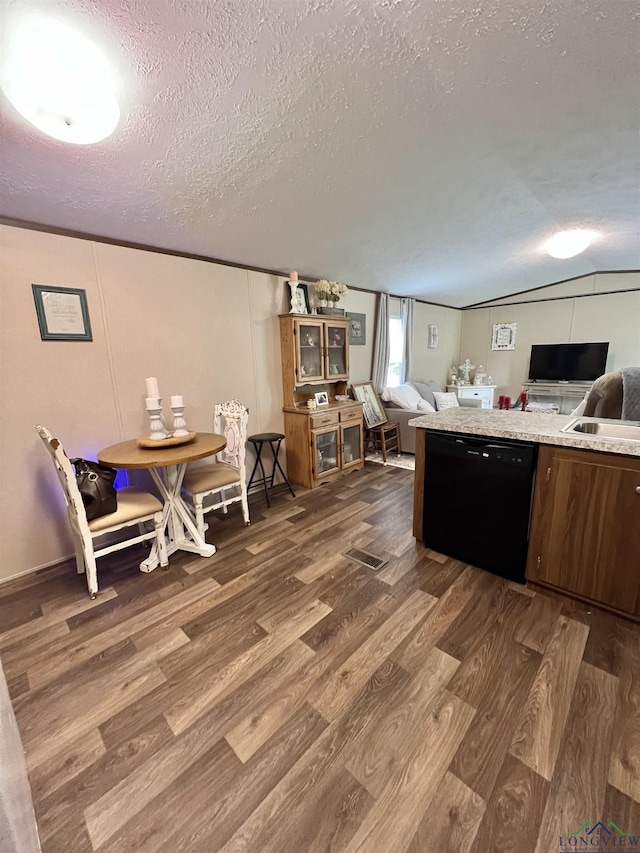 95 Montgomery St, Avinger, TX 75630 - kitchen with black dishwasher, dark wood-type flooring, a textured ceiling, open floor plan, and light countertops