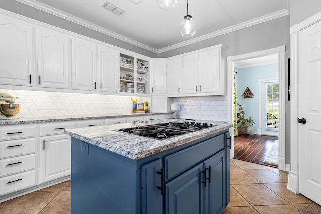 215 Sugar Creek Ln, Longview, TX 75605 - kitchen with blue cabinetry, gas cooktop, crown molding, white cabinetry, and light tile patterned flooring