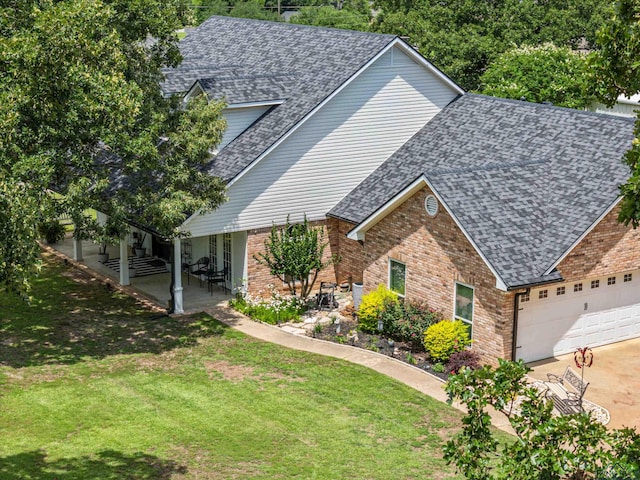 215 Sugar Creek Ln, Longview, TX 75605 - view of front facade featuring roof with shingles, brick siding, a front lawn, and a garage
