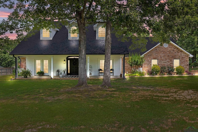 215 Sugar Creek Ln, Longview, TX 75605 - cape cod-style house with a front yard, covered porch, and a shingled roof