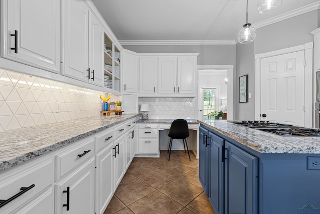 215 Sugar Creek Ln, Longview, TX 75605 - kitchen with blue cabinetry, gas cooktop, white cabinets, tasteful backsplash, and decorative light fixtures