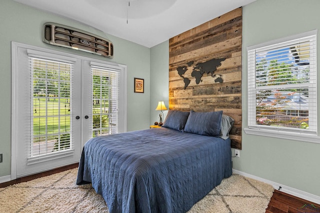 215 Sugar Creek Ln, Longview, TX 75605 - bedroom with access to outside, wood walls, french doors, baseboards, and wood finished floors