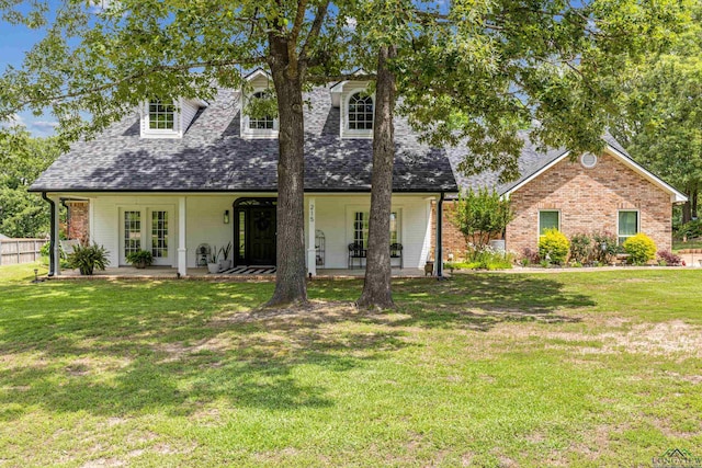 215 Sugar Creek Ln, Longview, TX 75605 - cape cod house featuring roof with shingles, brick siding, and a patio area
