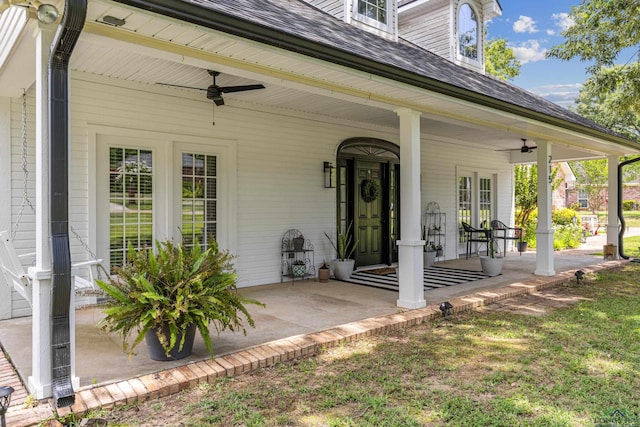 215 Sugar Creek Ln, Longview, TX 75605 - view of exterior entry with ceiling fan, a porch, and a shingled roof