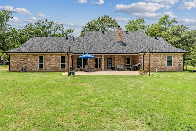 215 Sugar Creek Ln, Longview, TX 75605 - rear view of property with a yard, a patio area, brick siding, a chimney, and a shingled roof