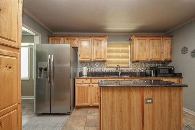 kitchen with appliances with stainless steel finishes, a sink, decorative backsplash, a center island, and crown molding