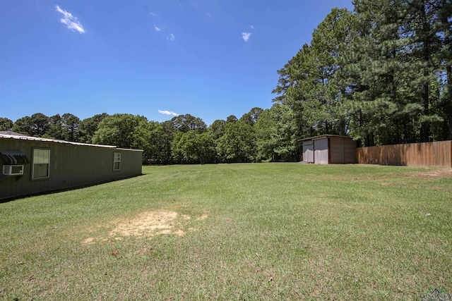 view of yard featuring a storage unit, a garage, and an outbuilding