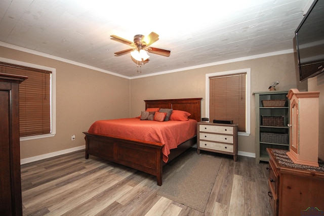 bedroom with wood finished floors, baseboards, a ceiling fan, and ornamental molding