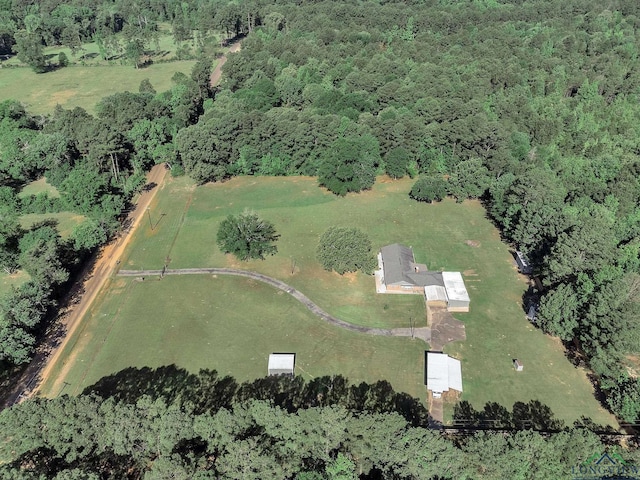 view of property location with a forest and rural landscape