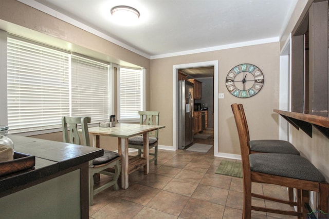 dining room with light tile patterned flooring and baseboards