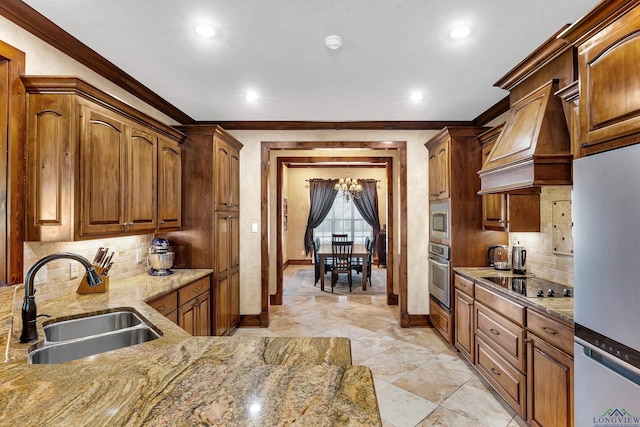 kitchen with backsplash, sink, crown molding, light stone countertops, and appliances with stainless steel finishes