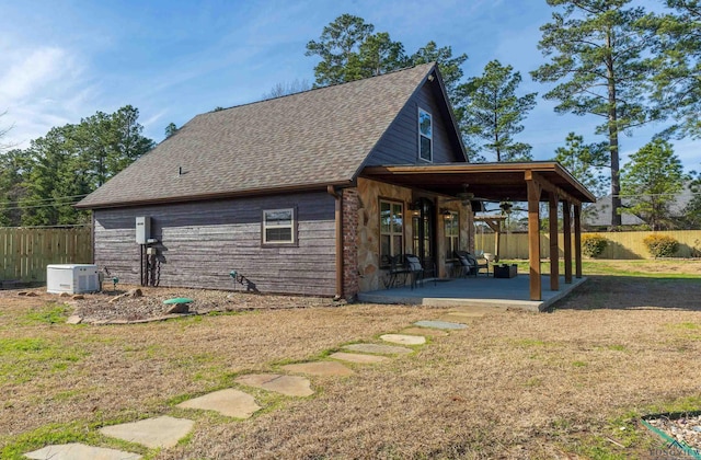 view of side of home featuring a yard and a patio