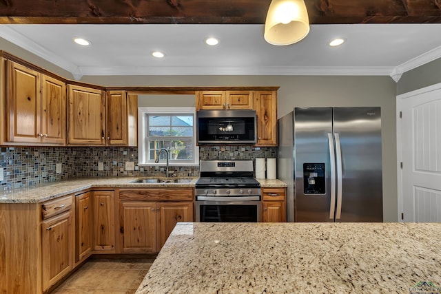 kitchen with light stone counters, sink, appliances with stainless steel finishes, and tasteful backsplash