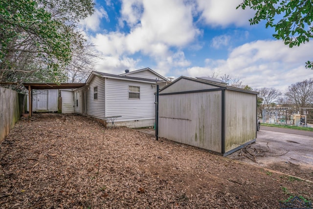 exterior space with an outdoor structure, fence, and a shed