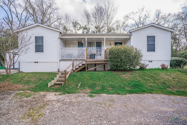 view of front facade featuring crawl space, a porch, a front yard, and stairway