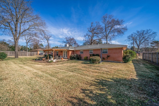 rear view of house featuring a lawn and a patio area