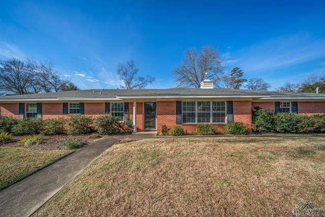 ranch-style home with a front lawn