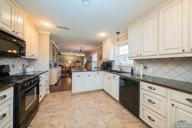 kitchen with sink, kitchen peninsula, crown molding, pendant lighting, and black appliances