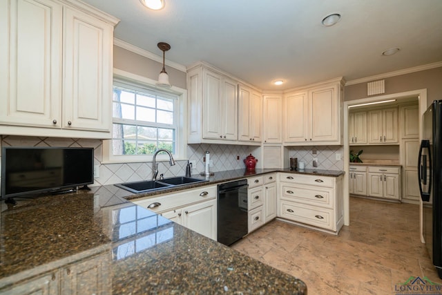 kitchen with pendant lighting, dark stone counters, white cabinets, black appliances, and sink