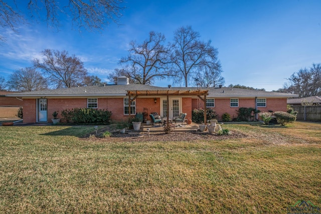 back of property with a patio area and a lawn