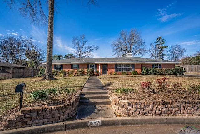 single story home with a front lawn