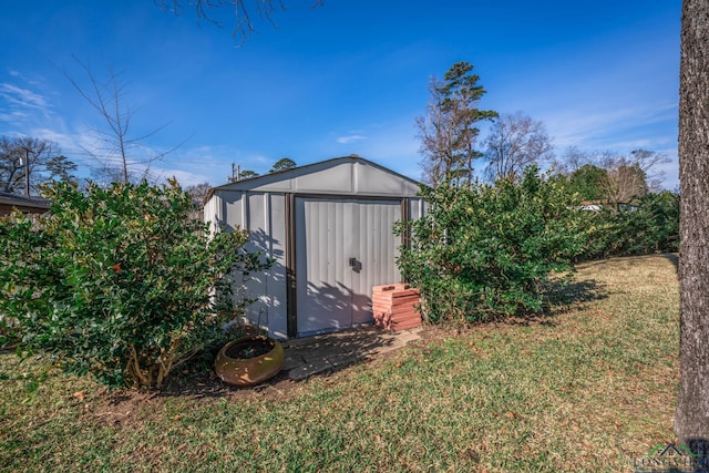 view of outdoor structure with a lawn