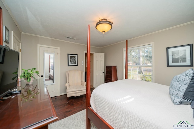 bedroom featuring crown molding and dark wood-type flooring