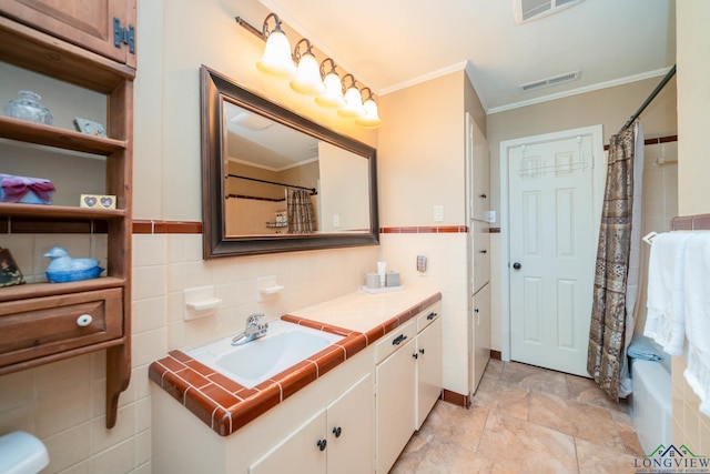 bathroom with shower / bath combination with curtain, vanity, and ornamental molding