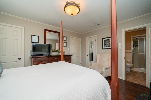 bedroom featuring dark hardwood / wood-style floors, crown molding, and connected bathroom