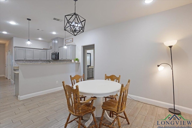 dining space with light wood-type flooring, baseboards, visible vents, and recessed lighting