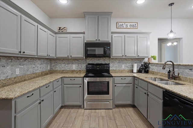 kitchen featuring gray cabinetry, a sink, and black appliances
