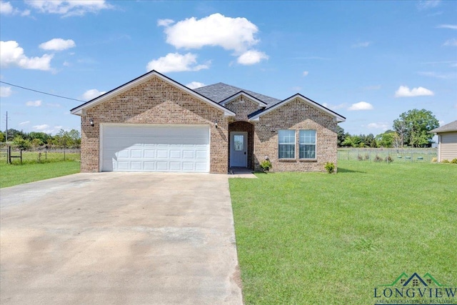 ranch-style home featuring fence, an attached garage, driveway, brick siding, and a front yard
