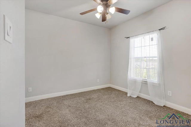 carpeted empty room with a ceiling fan and baseboards