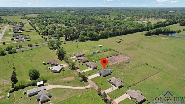 drone / aerial view featuring a rural view and a forest view