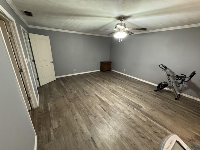 unfurnished bedroom featuring crown molding, ceiling fan, a textured ceiling, and dark hardwood / wood-style flooring