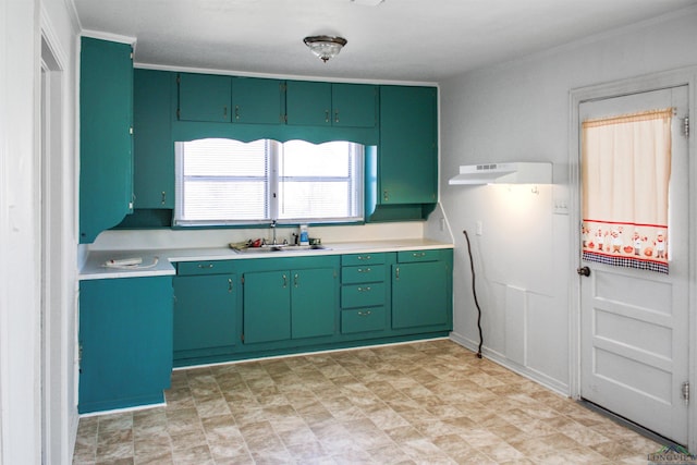 kitchen with crown molding, sink, and green cabinets