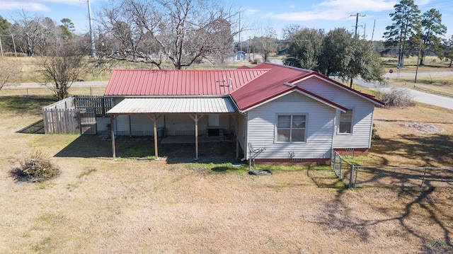 rear view of property with a lawn