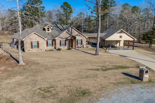 view of front of home with concrete driveway, roof with shingles, and a front yard