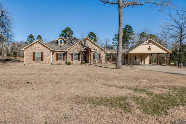 view of front of house with a carport, driveway, and brick siding