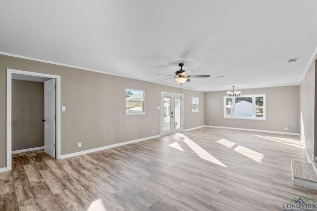 unfurnished living room with light hardwood / wood-style floors, ornamental molding, french doors, and ceiling fan with notable chandelier