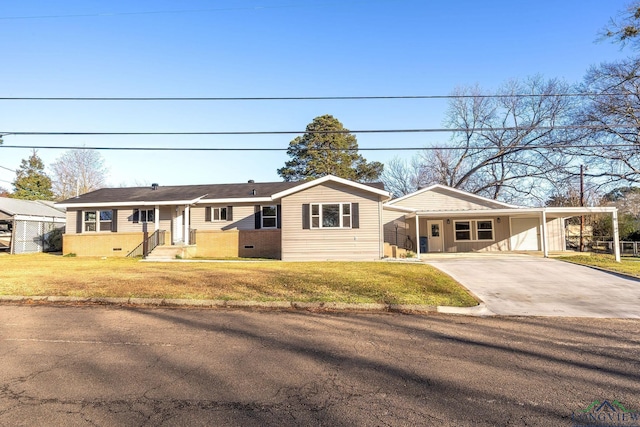 ranch-style home featuring a front lawn and a carport