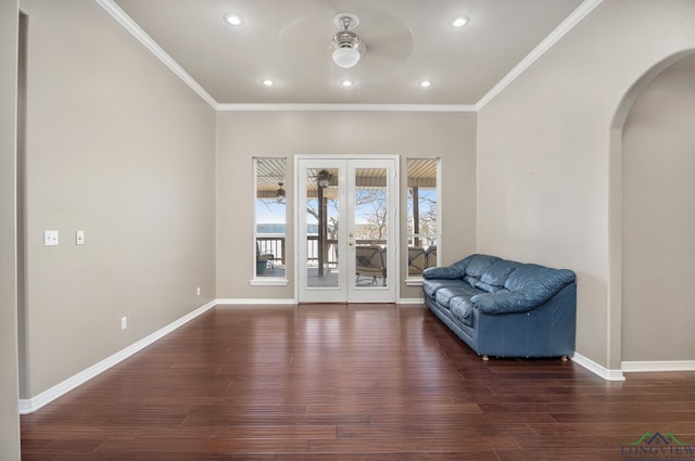 sitting room featuring dark hardwood / wood-style flooring, crown molding, and french doors