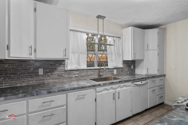 kitchen featuring white cabinets, dishwasher, sink, and hanging light fixtures