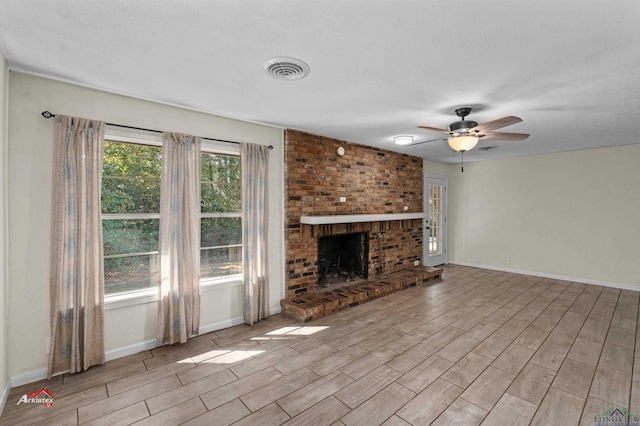 unfurnished living room with ceiling fan and a fireplace