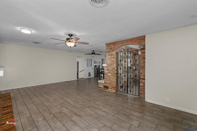 unfurnished living room with ceiling fan