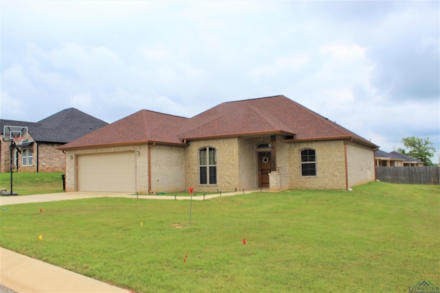 view of front of house featuring a front yard and a garage