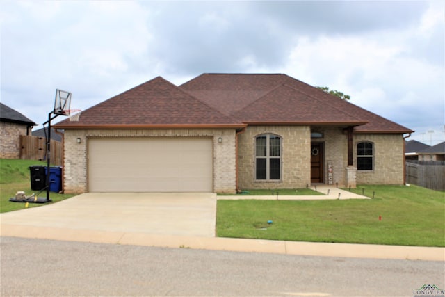 view of front of property with a garage and a front yard