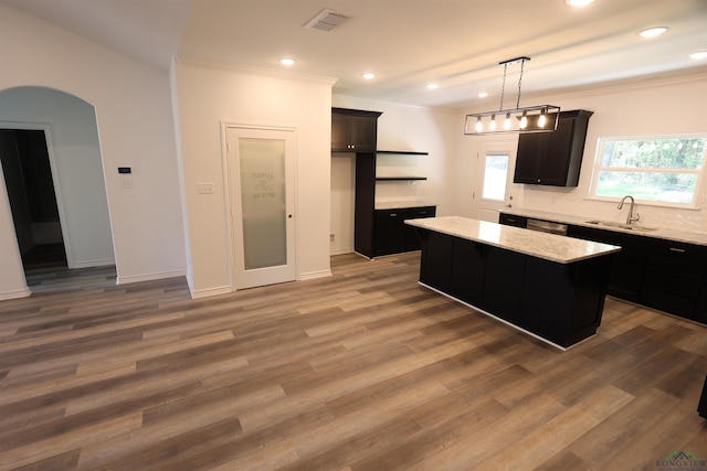 kitchen featuring a center island, hanging light fixtures, dark hardwood / wood-style floors, and sink