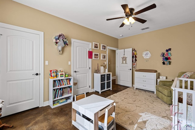 bedroom featuring a nursery area, ceiling fan, and dark carpet