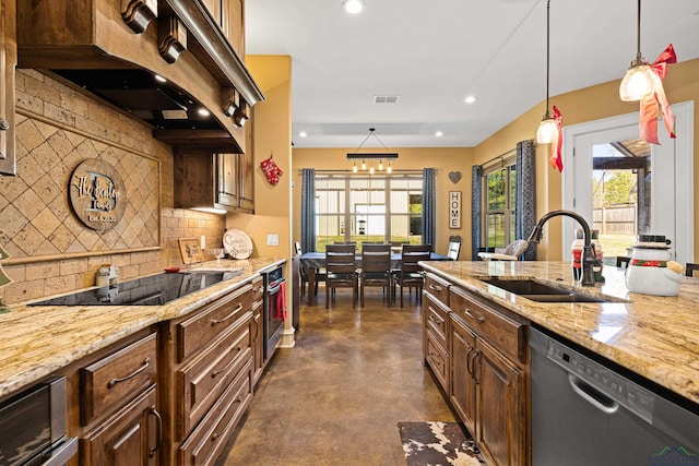 kitchen featuring tasteful backsplash, appliances with stainless steel finishes, sink, and pendant lighting